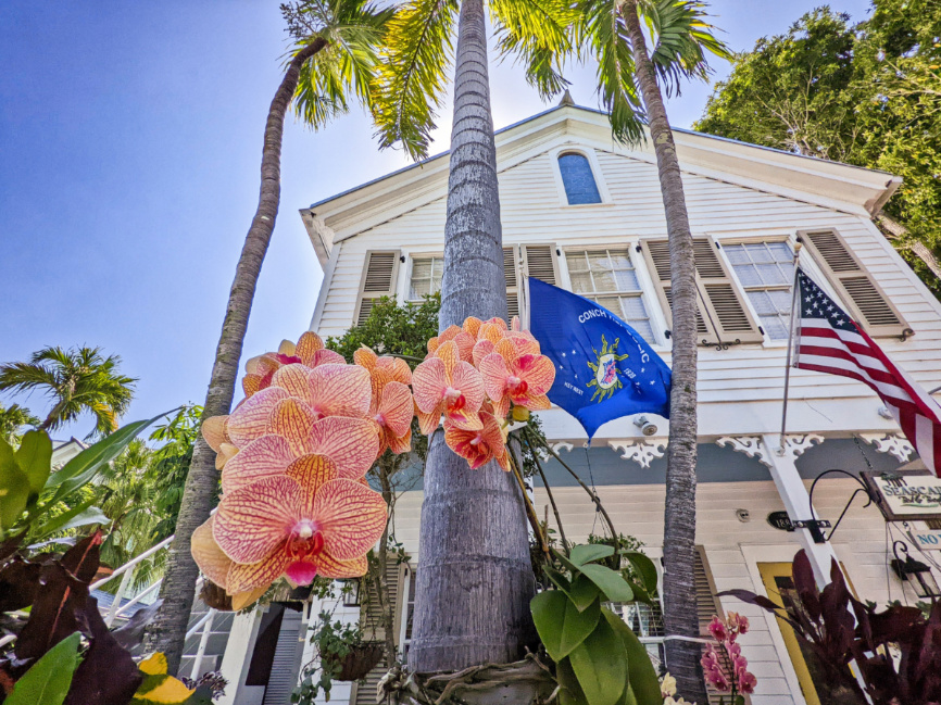 Conch Republic Flag with Orchids and Colorful House in Historic Key West Florida Keys 2